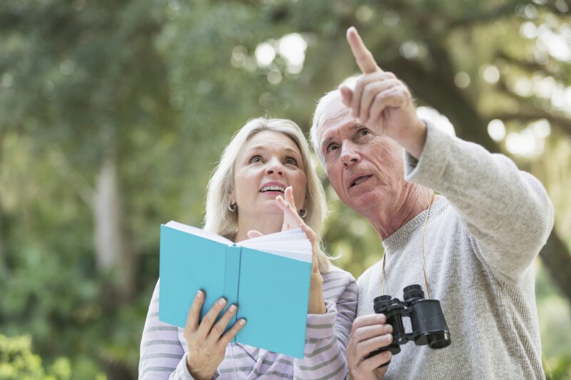 Senior couple in the woods birdwatching