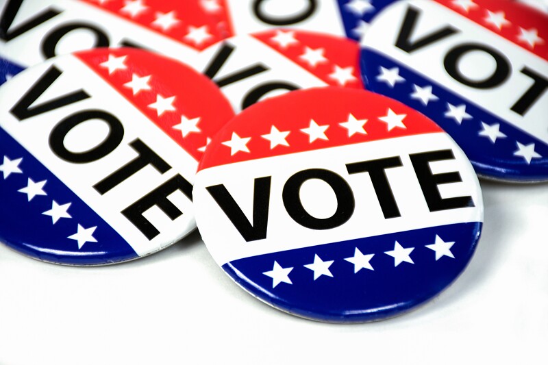 close up of campaign voting flag pins on white