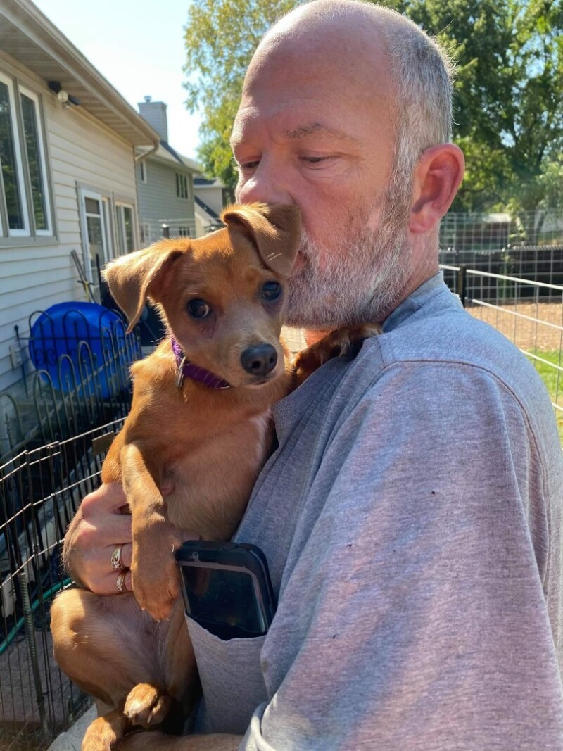 man holding a small dog
