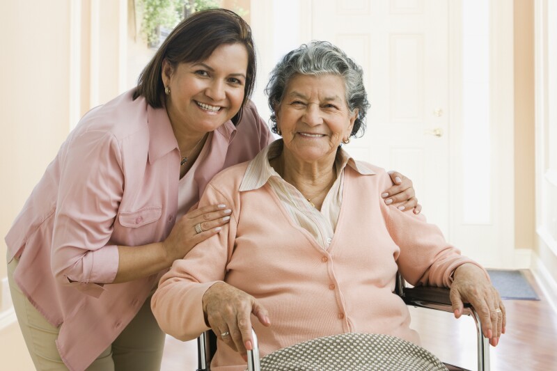 Senior Hispanic woman and adult daughter hugging
