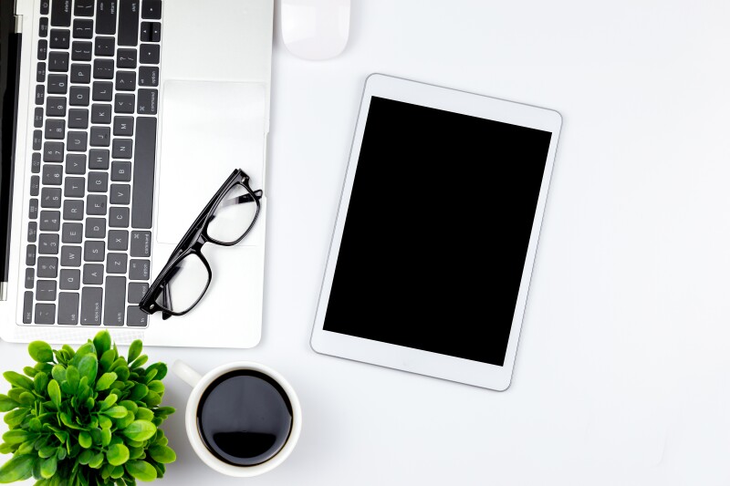 Directly Above Shot Of Digital Tablet With Laptop And Coffee On White Background
