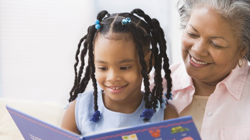 African grandmother and granddaughter reading