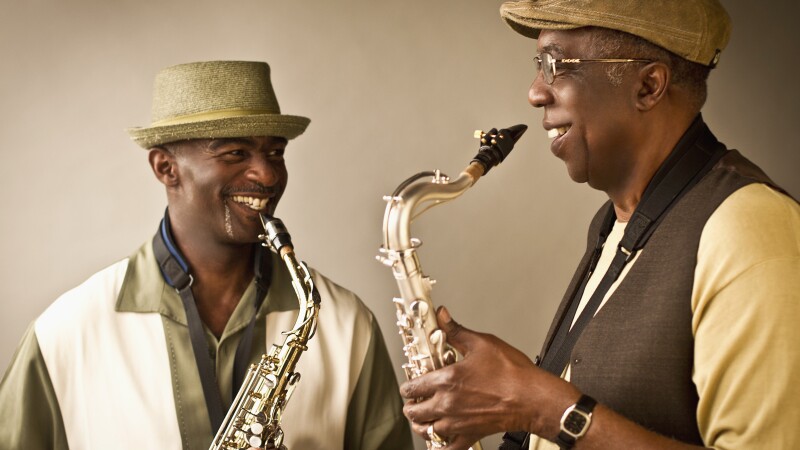 African American musicians playing saxophones together