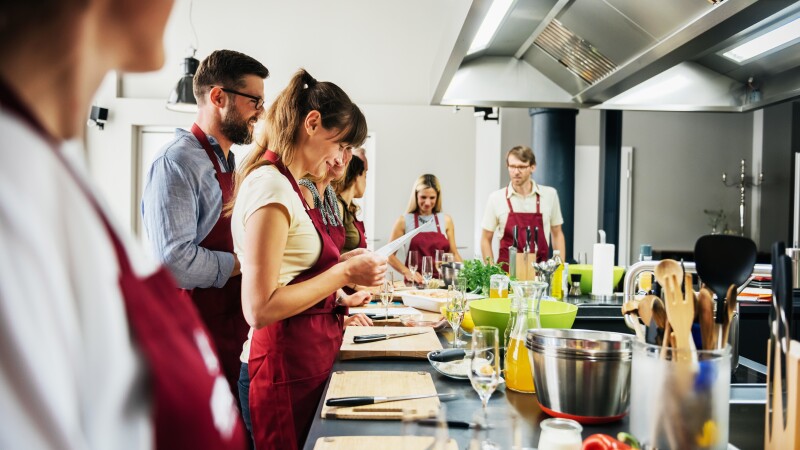 Woman studying recipe in cooking class