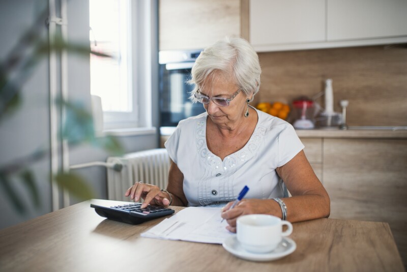 Stressed senior woman is doing banking and administrative work at home