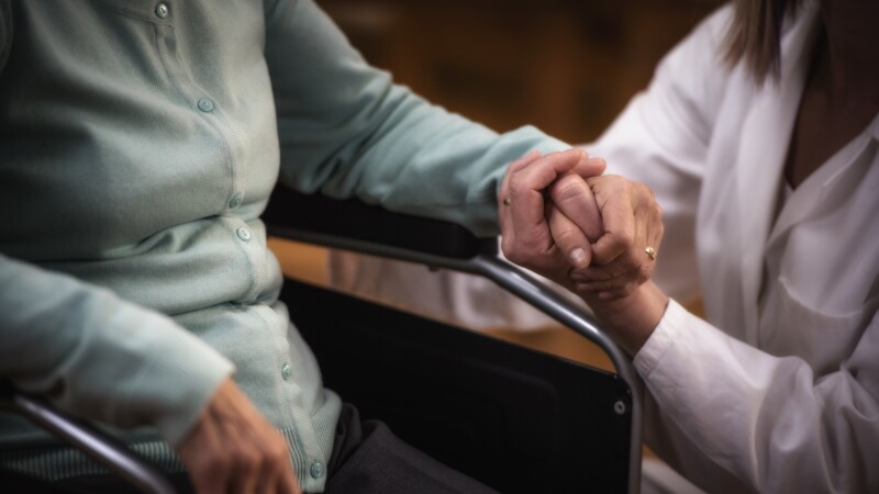 Nurse during home visit with senior woman