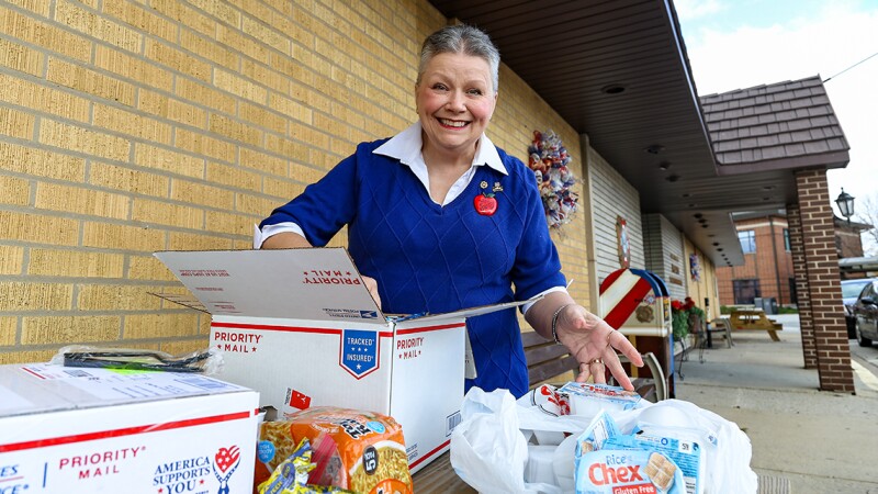 A woman packing boxes with food
