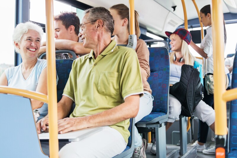 People communicate while riding the bus.
