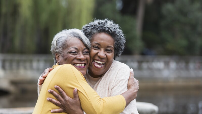 Senior black women embracing