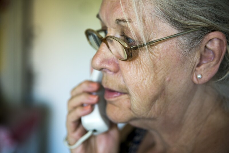 worried mature woman talking on telephone
