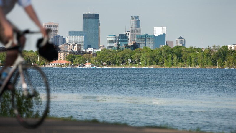 Minneapolis lifestyle scenic with biker on Lake Calhoun.