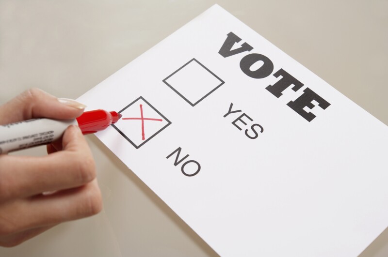 Caucasian woman voting no on ballot