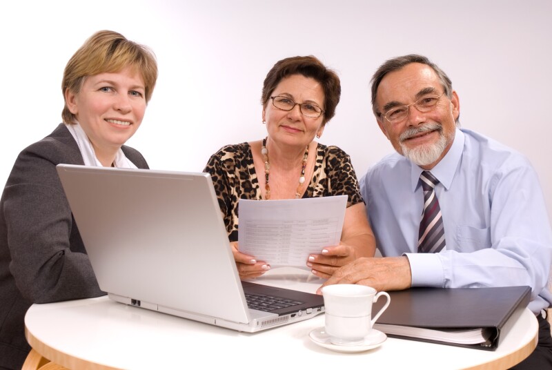 Mature couple talking to financial planner