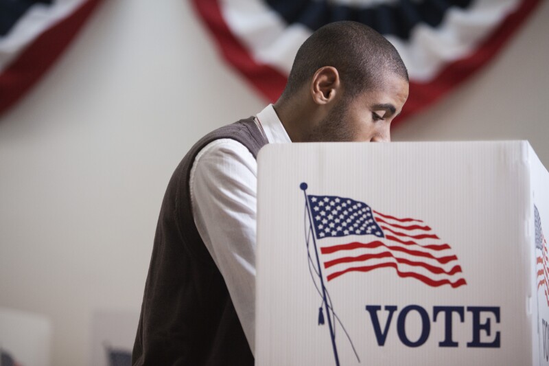 Hispanic voter voting in polling place