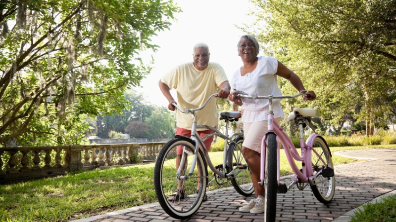 Senior African American couple riding bicycles