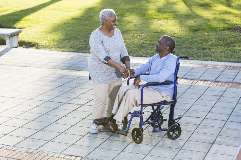 Senior African American couple, man in wheelchair