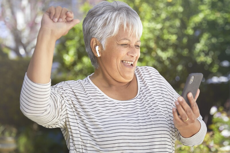 Happy senior woman dancing in her garden
