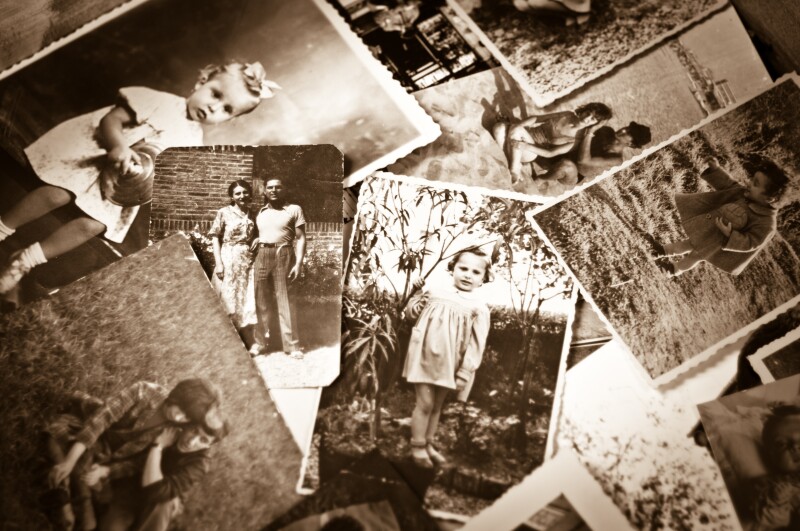 A pile of old black and white photographs