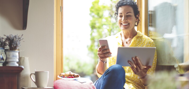 Mature woman is purchasing online at home