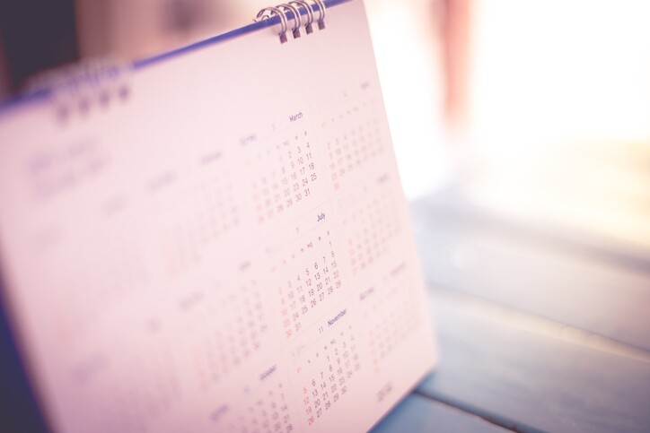 Blurred calendar page blue background.