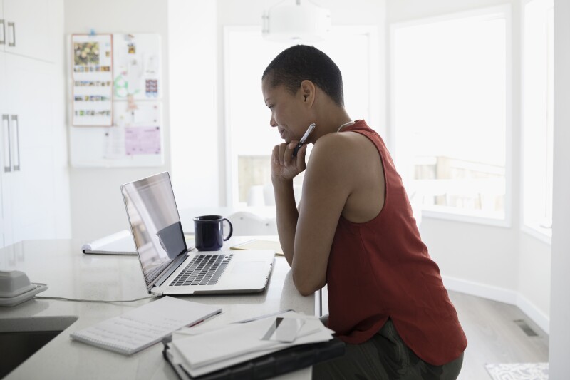 Mature woman using laptop in kitchen