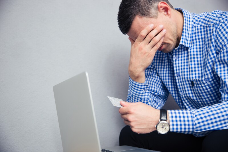 Upset man holding credit card