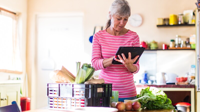 Woman receiving grocery delivery.