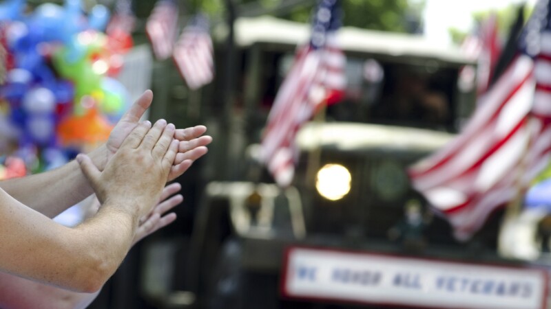 hands clapping at veterans parade