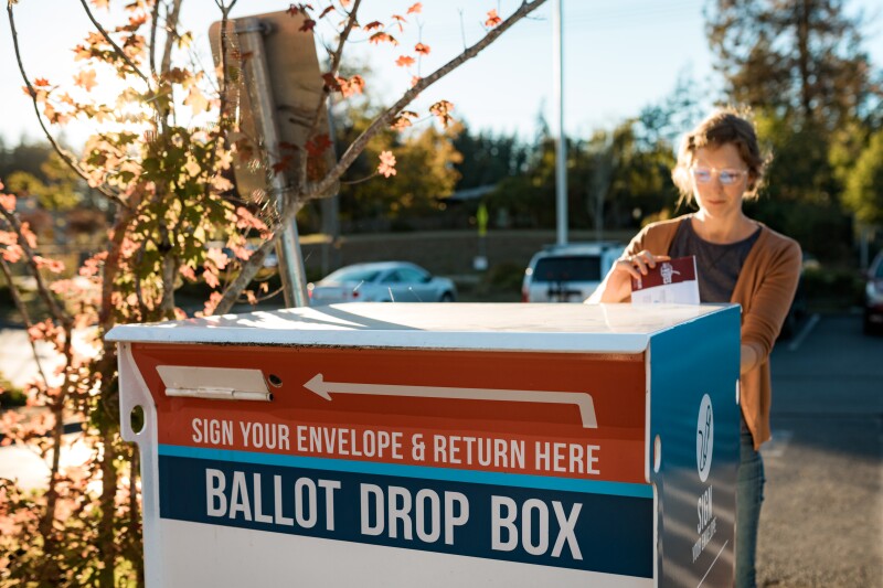 Woman Deposits Absentee Mail-In Voters Ballot