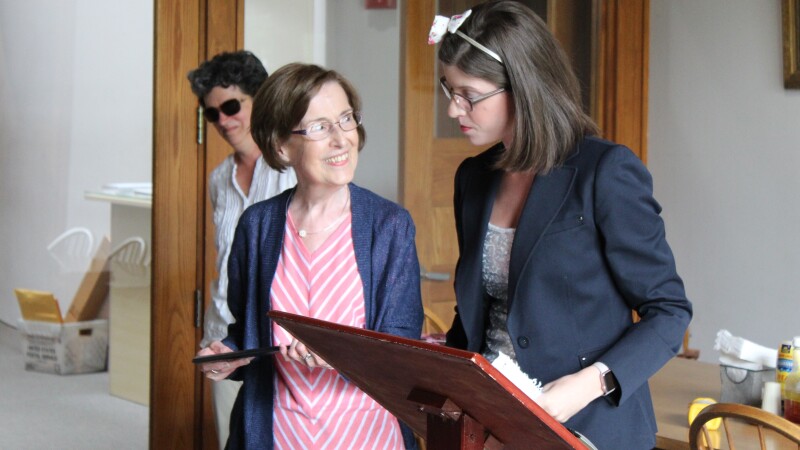 Two women stand at a podium