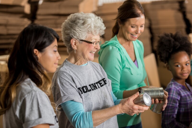 Team of diverse food bank volunteers receive donations