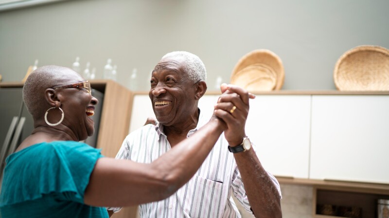 Senior couple dancing at home