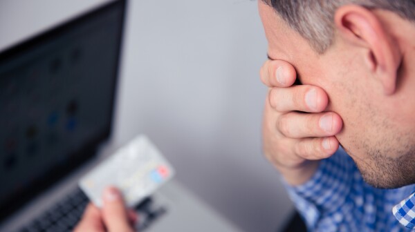 Upset man holding credit card