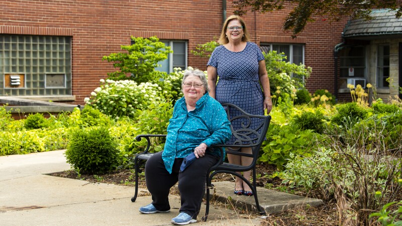 Two women outside of a senior-living facility
