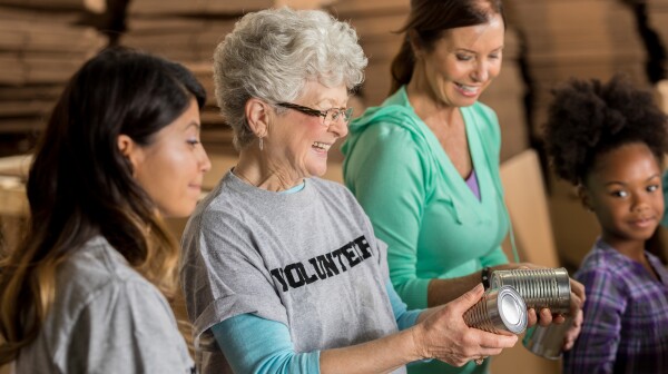 Team of diverse food bank volunteers receive donations
