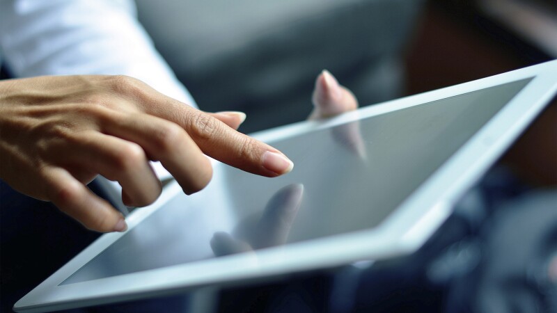 Finger pressing on digital tablet screen