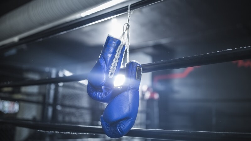 Boxing gloves hanging in boxing ring