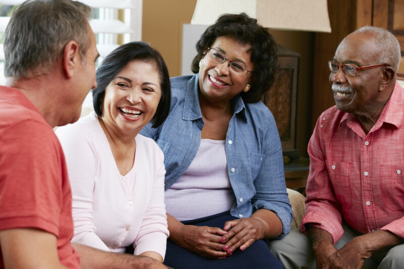 Group Of Senior Friends Chatting At Home Together