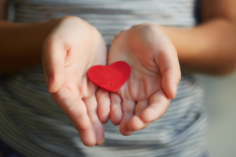 Little girl holding a red heart