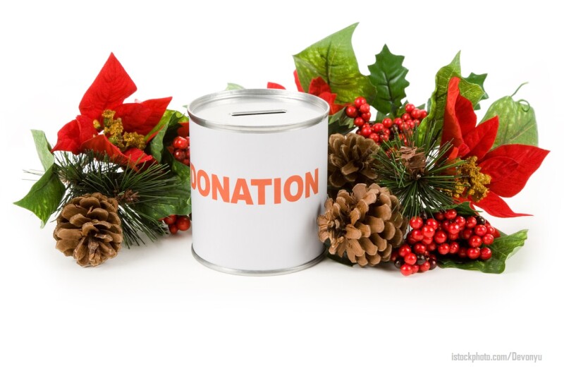 Donation can with Christmas poinsettia bouquet on white