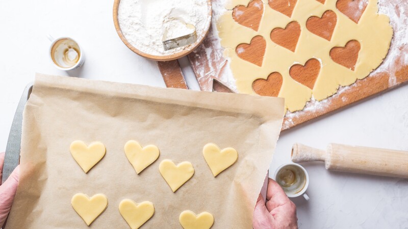 Man making Valentines day cookies, overheard view of holiday baking