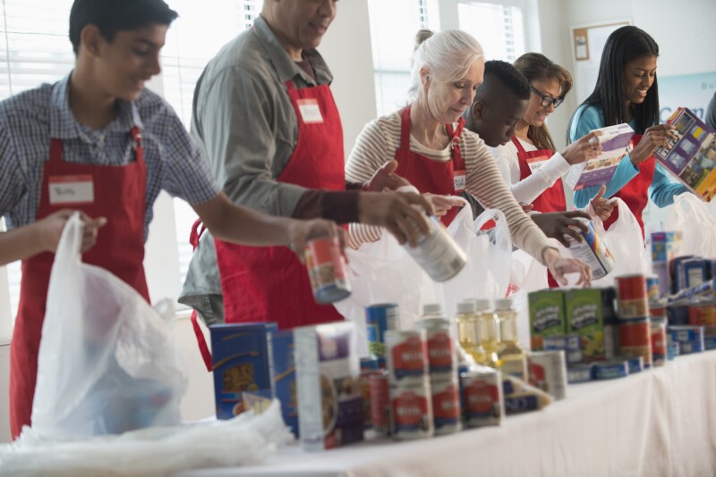 Volunteers packing canned goods at food drive