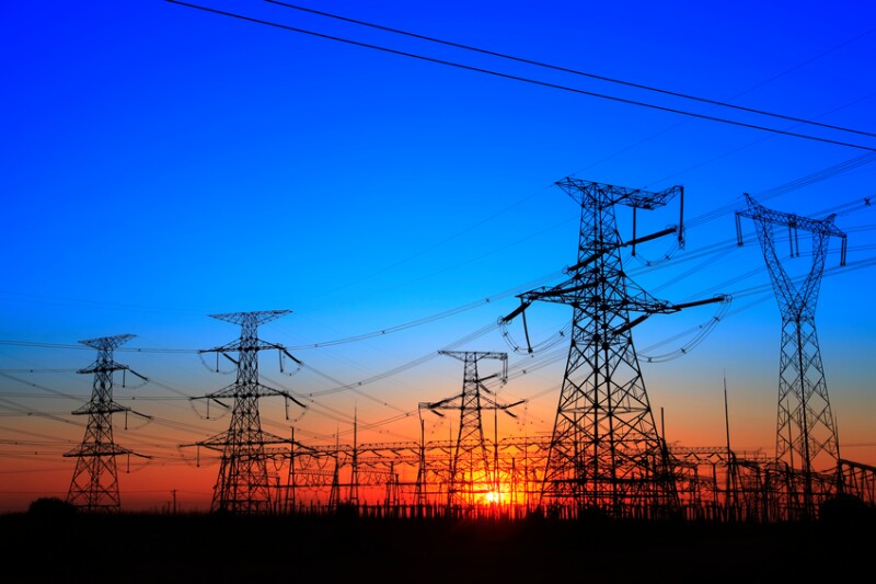 The silhouette of the evening electricity transmission pylon