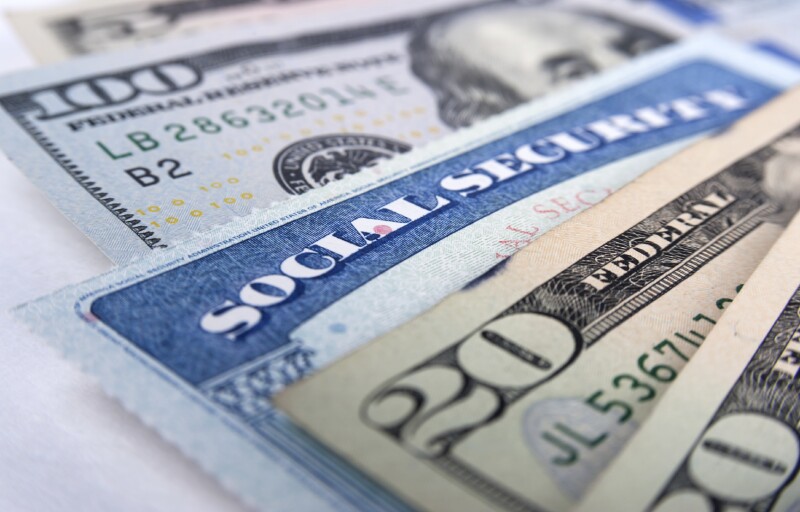 Social security card and American money dollar bills close up concept