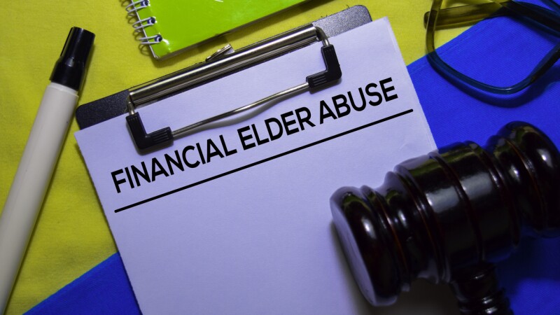 Financial Elder Abuse text on Document form and Gavel isolated on office desk.