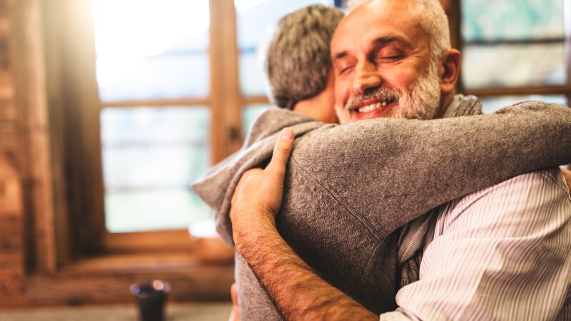 senior couple embracing passionate in the house - support concept