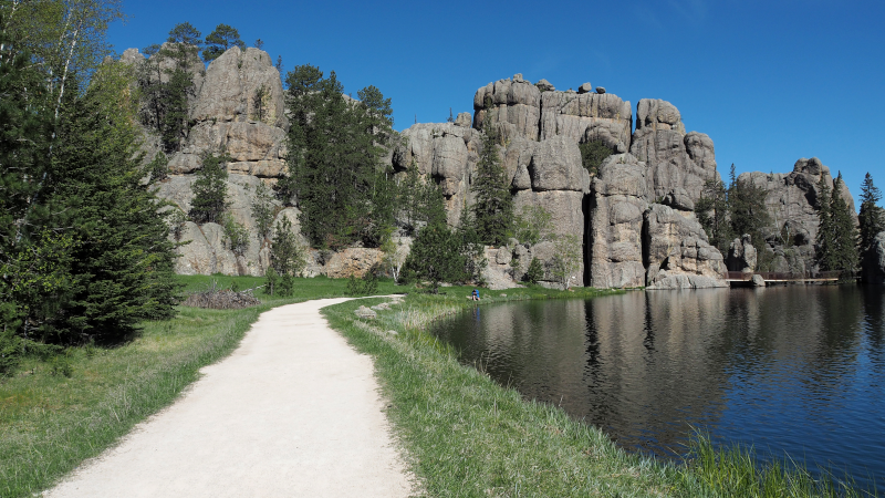 Path along a lake with rock formations in the South Dakota Black Hills