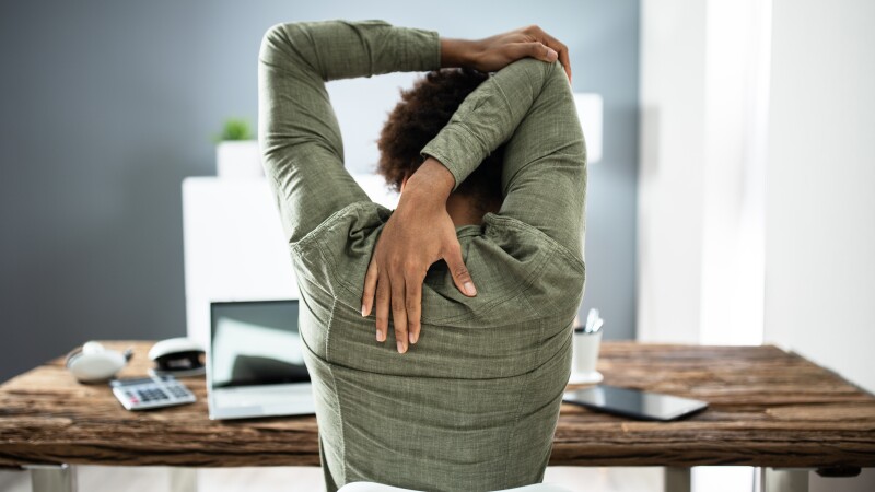 Rear View Of A Businessman Stretching His Arms