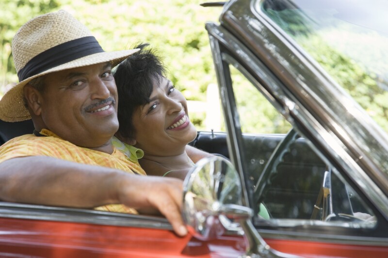 Portrait of a senior man and a mature woman sitting in a convertible car