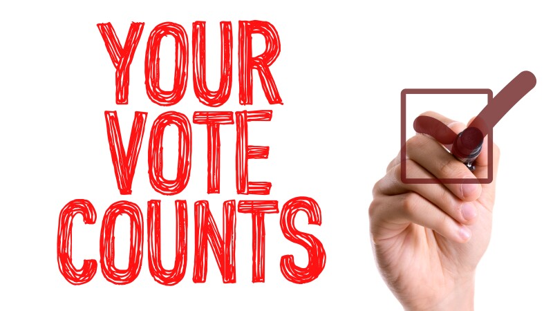 Hand with marker writing the word Your Vote Counts